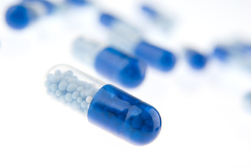 Blue pills isolated on white background