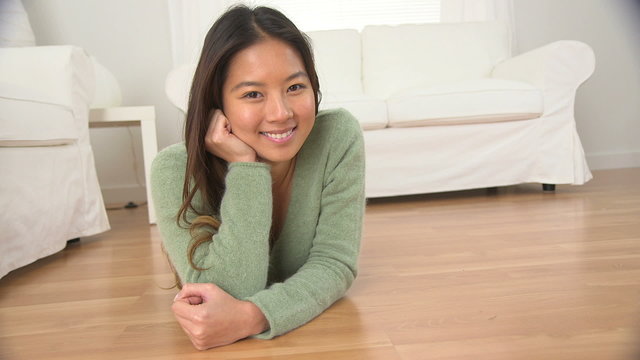 Portrait of Asian woman lying on floor