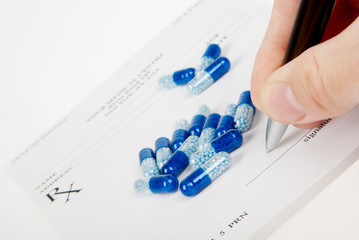 Doctor filling in empty medical prescription