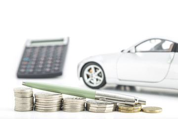 Coins with car, pen and calculator