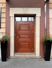 beautiful door with two flowerpots