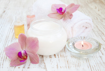 Fototapeta na wymiar moisturizing cream with pink orchids