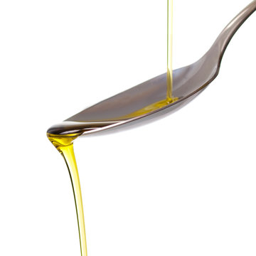 Olive oil pouring on a spoon