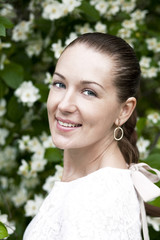 Portrait of beautiful brunette in spring blossom