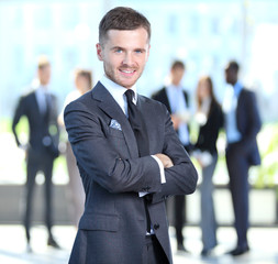 Happy smart business man with team mates discussing