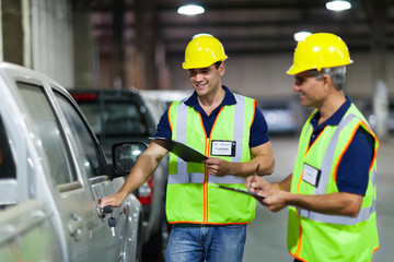 shipping company workers inspecting vehicle