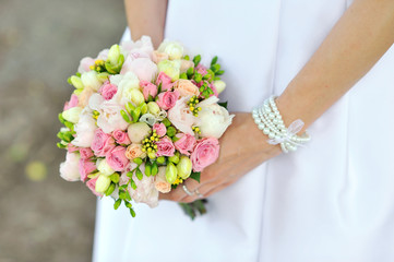 Bride holding wedding bouquet in hands