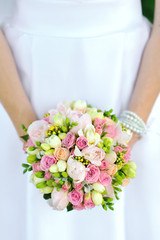 Bride holding wedding bouquet in hands