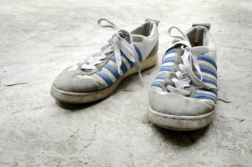 Old Running Shoes with concrete floor
