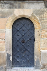 Fototapeta na wymiar Medieval front door in the downtown of Prague, Czech Republic