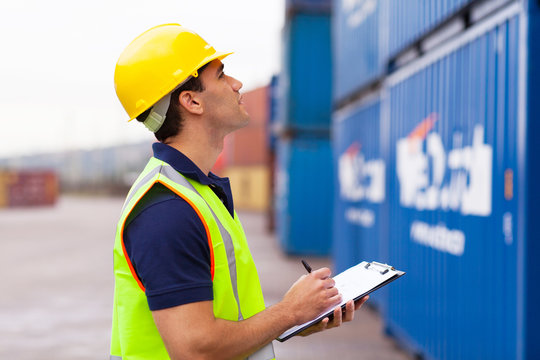 warehouse worker recording containers