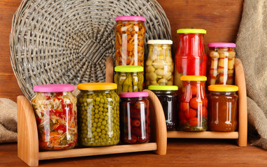 Different conservations on shelves on wooden background