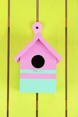 Decorative nesting box on color wooden background