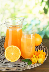 Obraz na płótnie Canvas Glass and pitcher of orange juice