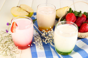 Delicious yogurts with fruits in glasses