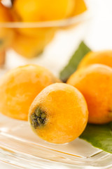 Loquat on the glass plate with white background