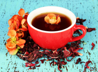 Herbal tea in cup, on color wooden background