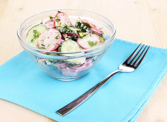 Vitamin vegetable salad in bowl on wooden table close-up