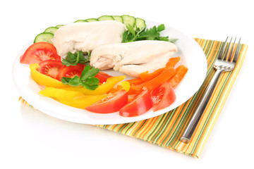 Boiled chicken breast on plate with vegetables close up
