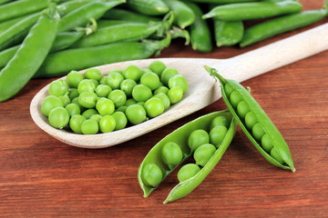 Sweet green peas on wooden background