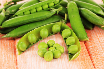 Sweet green peas on wooden background