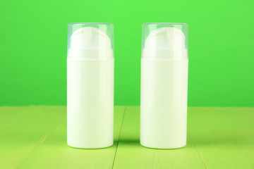 Bottle with cream, on color background