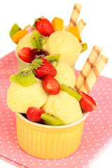 Delicious  ice cream with fruits and berries in bowl close up