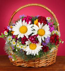 Beautiful bright flowers in wicker basket