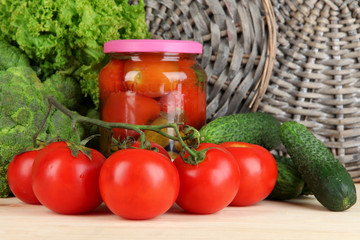 Fresh vegetables and canned on wooden table close up