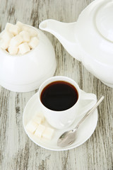 Cup of coffee, on color wooden background