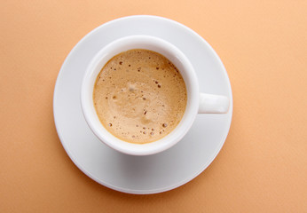 Cup of coffee on beige background