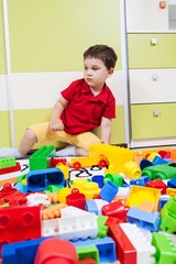 Little boy who play with plastic cubes