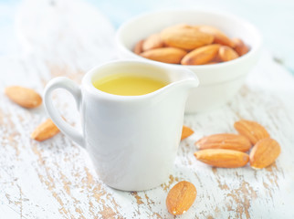 almond essential oil and almond in bowl