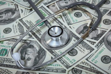 Stethoscope with U.S. dollar banknotes