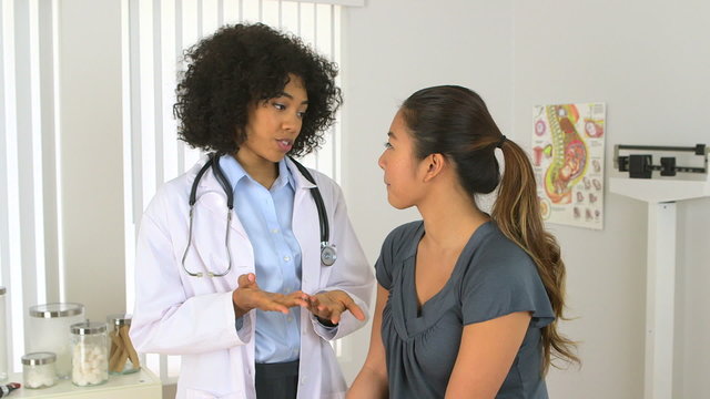 African American Doctor talking to asian patient