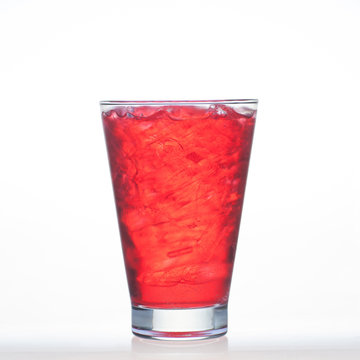 Sparkling red color drinks with water soda in glass isolated