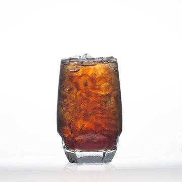 Sparkling cola soft drinks with soda water in glass isolated