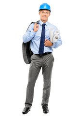 Confident young businessman holding blueprints on white backgrou