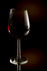 Low key image of red wine in a glass