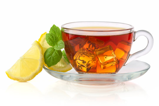 Cold tea with ice cube, lemon and mint isolated on white backgro