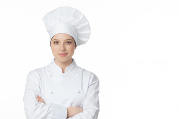 A young, female chef in a traditional hat and coat..