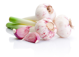 Three bulbs of fresh garlic and pieces isolated on white backgro