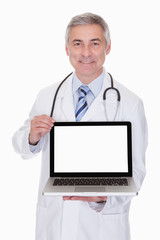 Portrait Of Male Doctor Showing Laptop