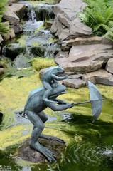Fototapeta na wymiar Statue of a frog with umbrella