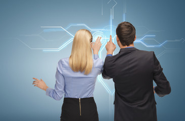 man and woman working with virtual screen