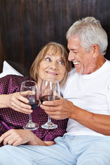 Senior couple celebrating with wine
