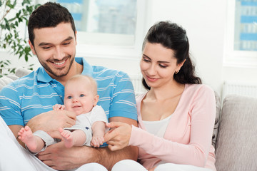 Obraz premium Happy young family with baby