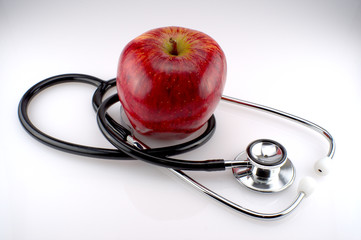 A stethoscope with a red apple