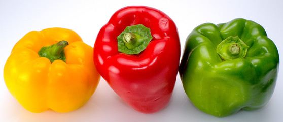 Three peppers of colors yellow, red and green