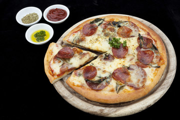 Tasty Italian pepperoni pizza with tomatoes.